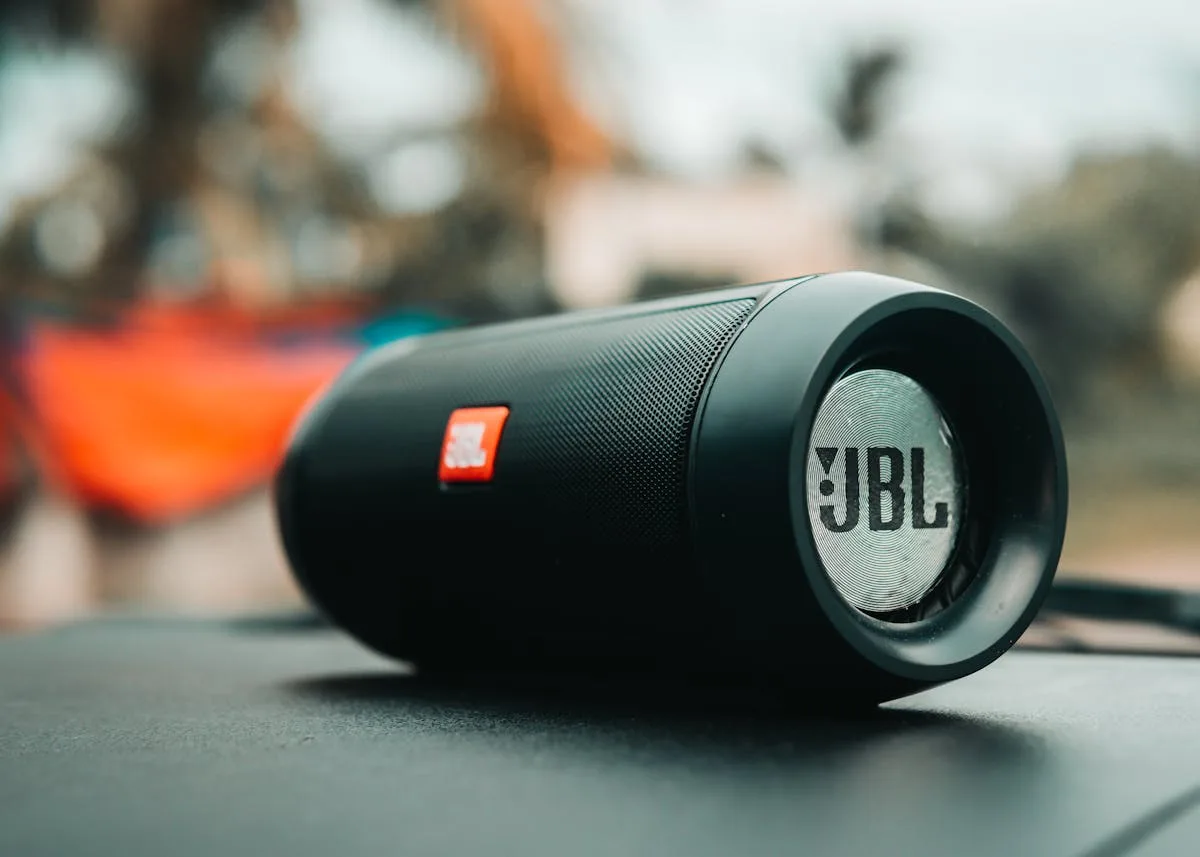 Portable JBL Bluetooth speaker on a wooden surface