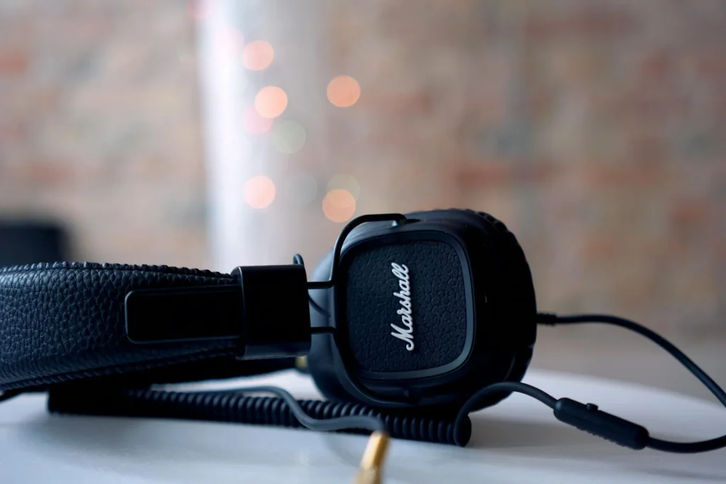 High-quality headphones on a table with warm bokeh lights in the background