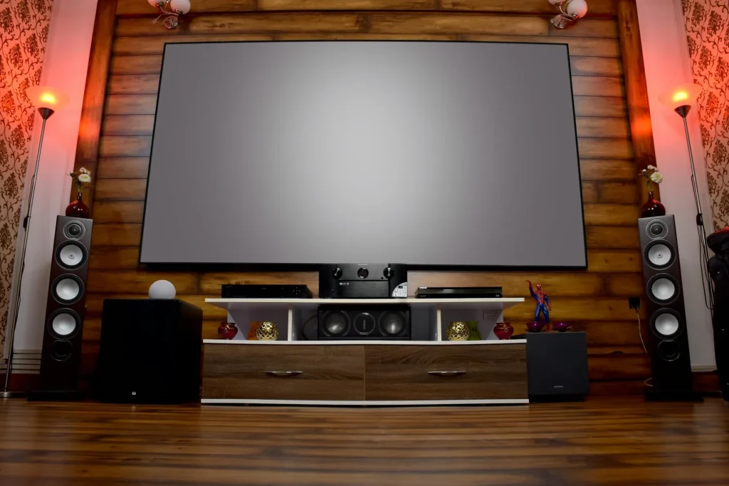 Pair of bookshelf speakers on stands in a modern living room