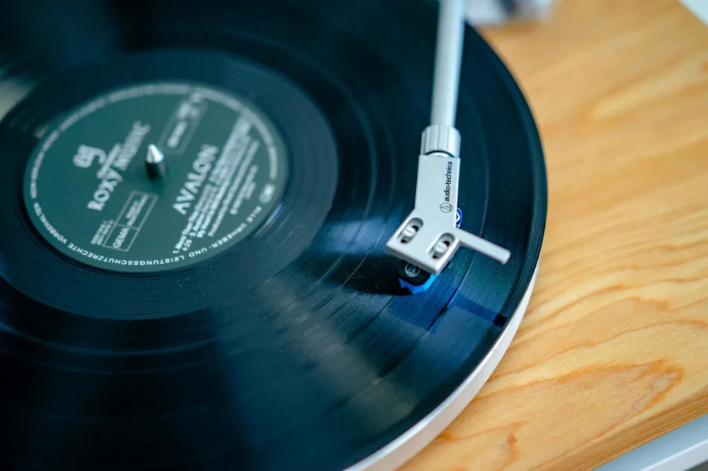 Close-up of a turntable playing a vinyl record with stylus on the groove