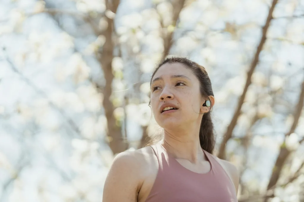 Runner wearing wireless earbuds during outdoor jog