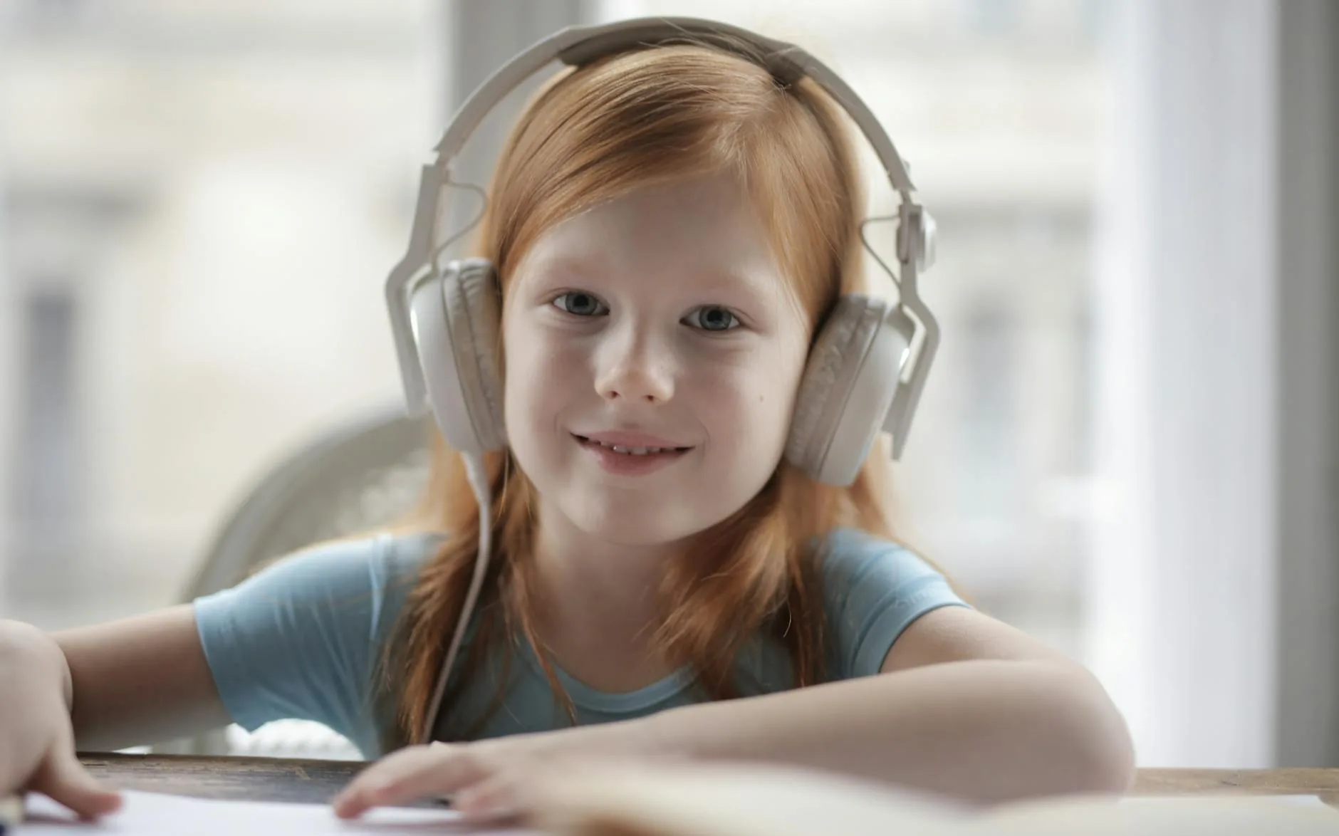 Girl listening to music with headphones and smiling