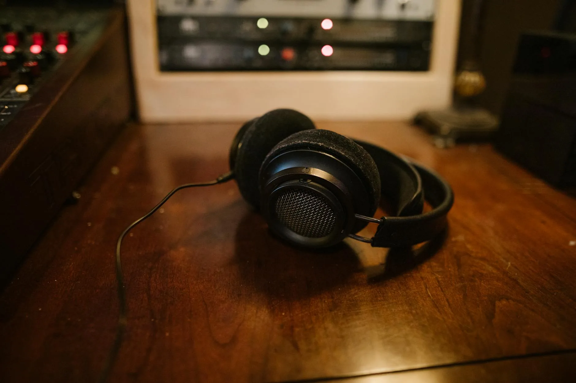 Headphones and audio equipment on a home studio desk