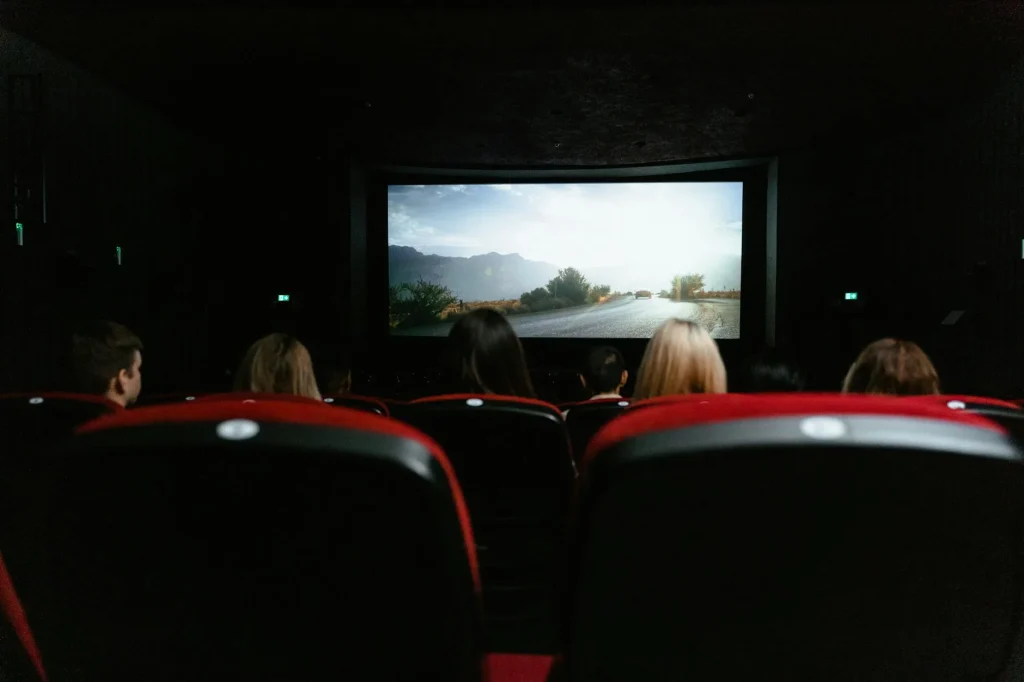 Home cinema projector displaying a movie on a large screen