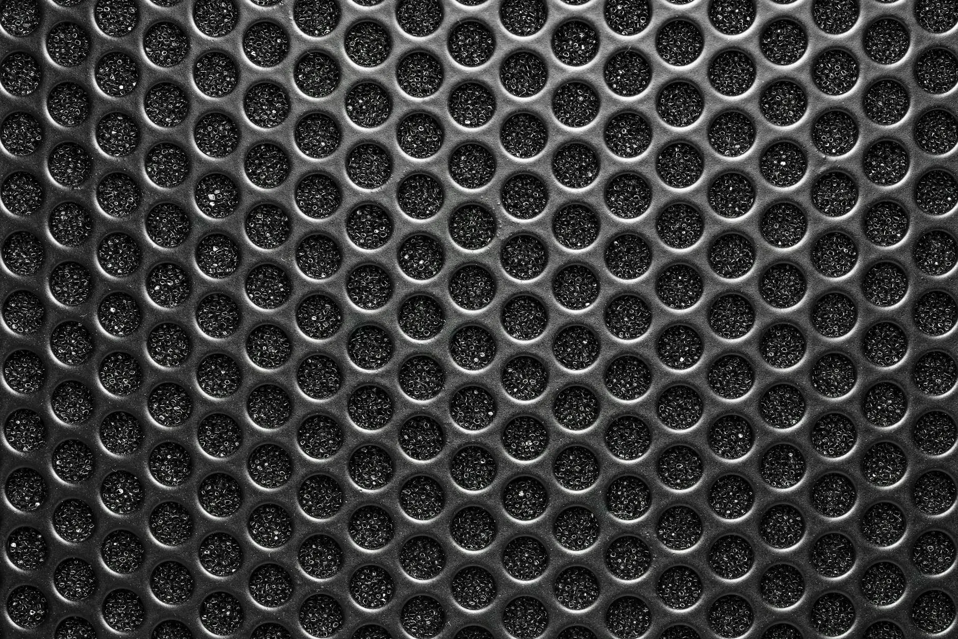 Open-back headphones showing the mesh grille on the ear cup