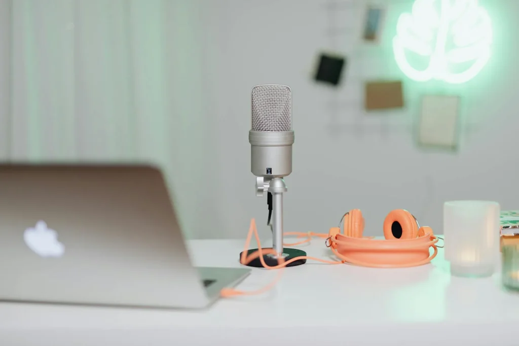 Podcast microphone on a desk in a home recording setup