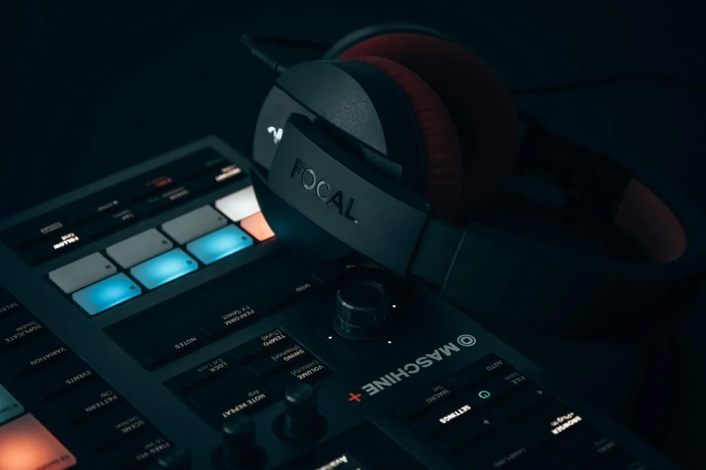 Professional studio headphones on a music production desk with mixer