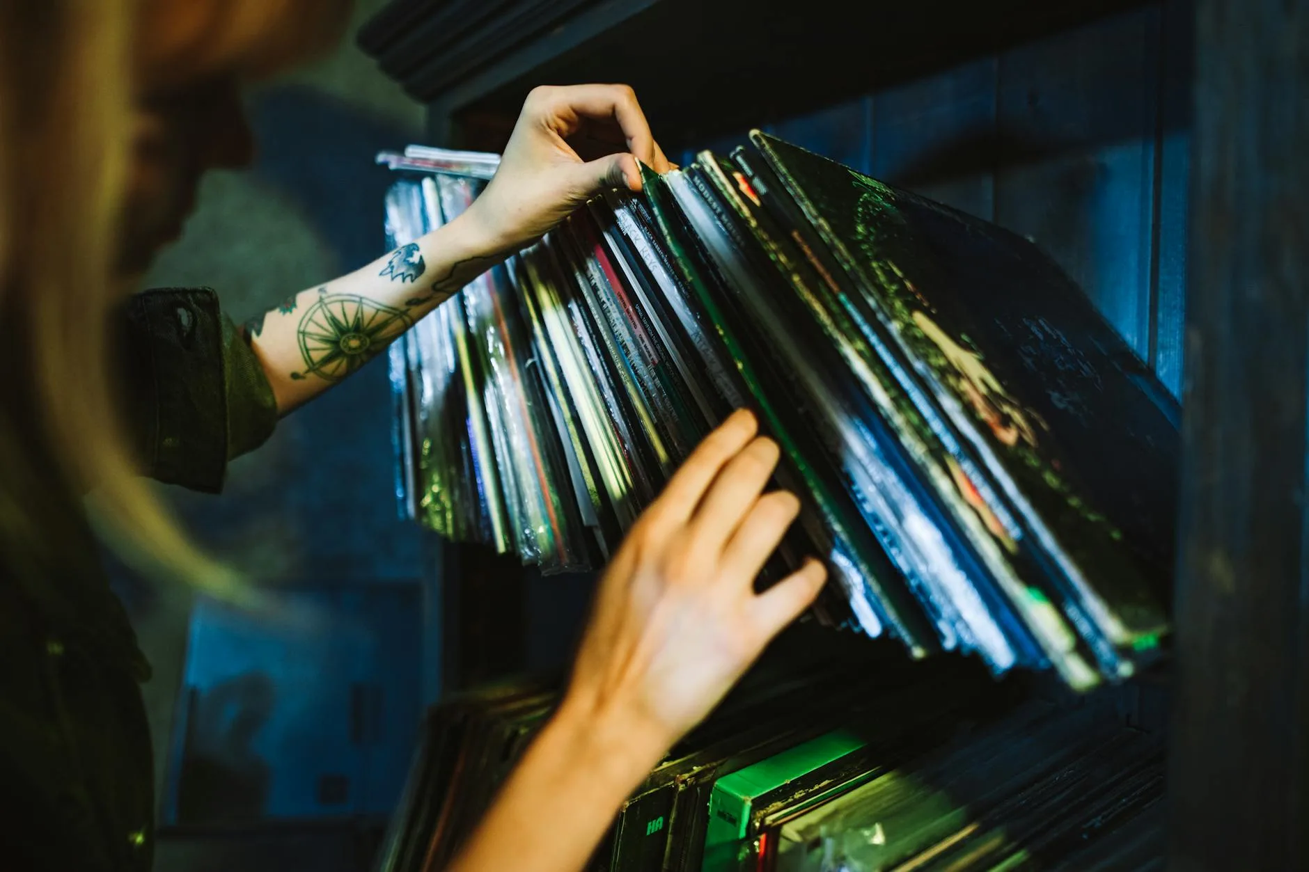 Collection of vinyl records on a shelf organised by album