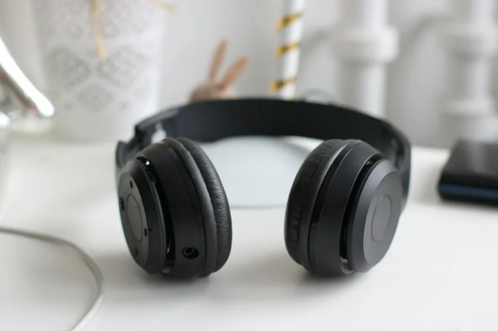 Wired and wireless headphones side by side on a desk