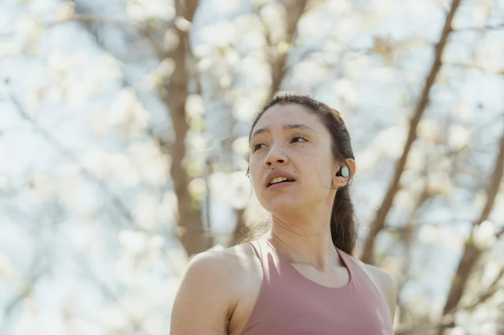 Person wearing wireless sport earbuds during a workout
