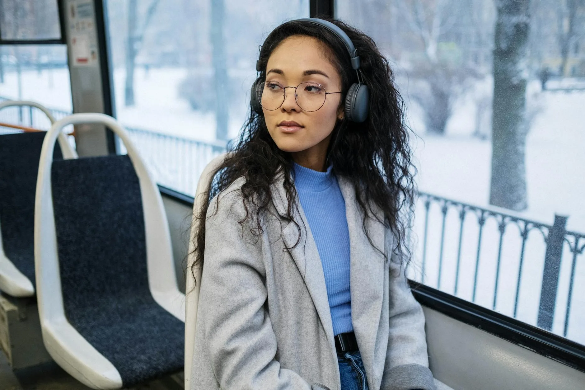 Person wearing wireless headphones during a commute