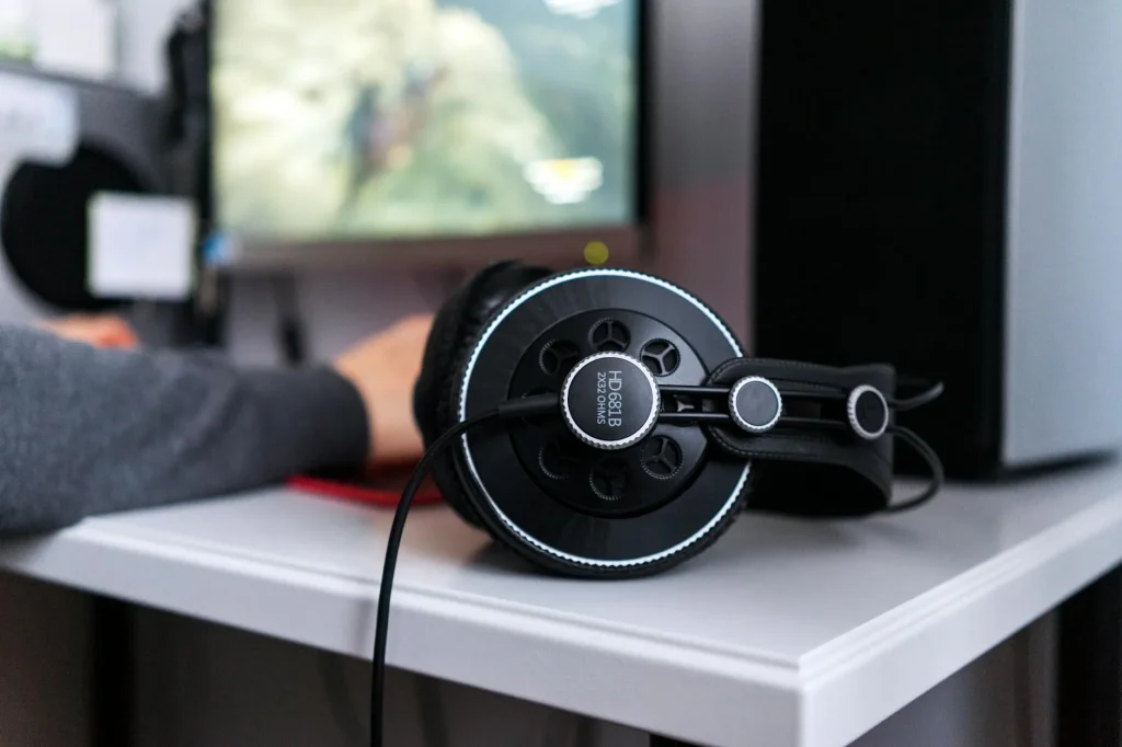 Headphones resting on a stand on a clean desk setup