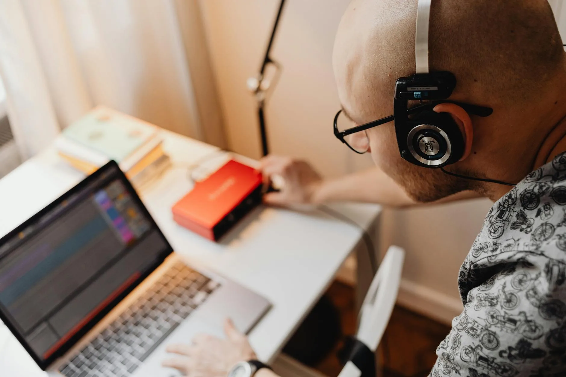 Headphone amplifier and DAC setup on a desk with cables