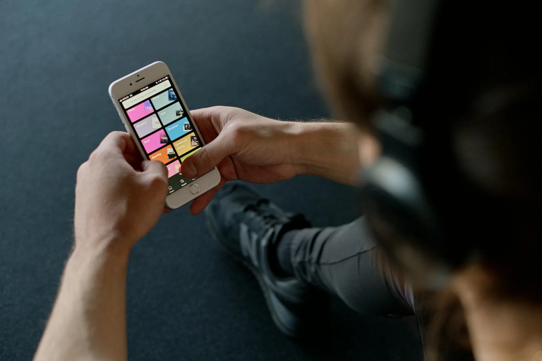 Smartphone showing music streaming app with headphones