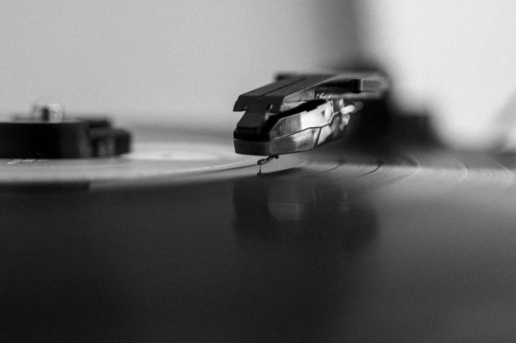 Turntable stylus lowered near a vinyl record groove