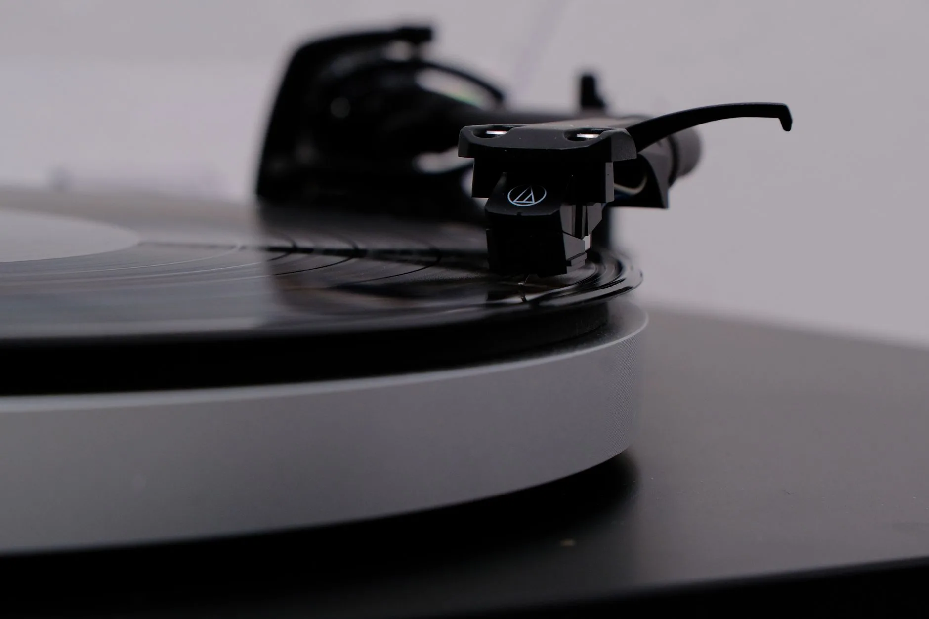 Turntable stylus tracking a vinyl record groove