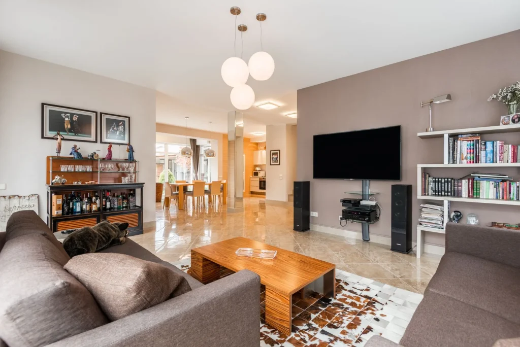 Bookshelf speakers positioned beside a living room TV
