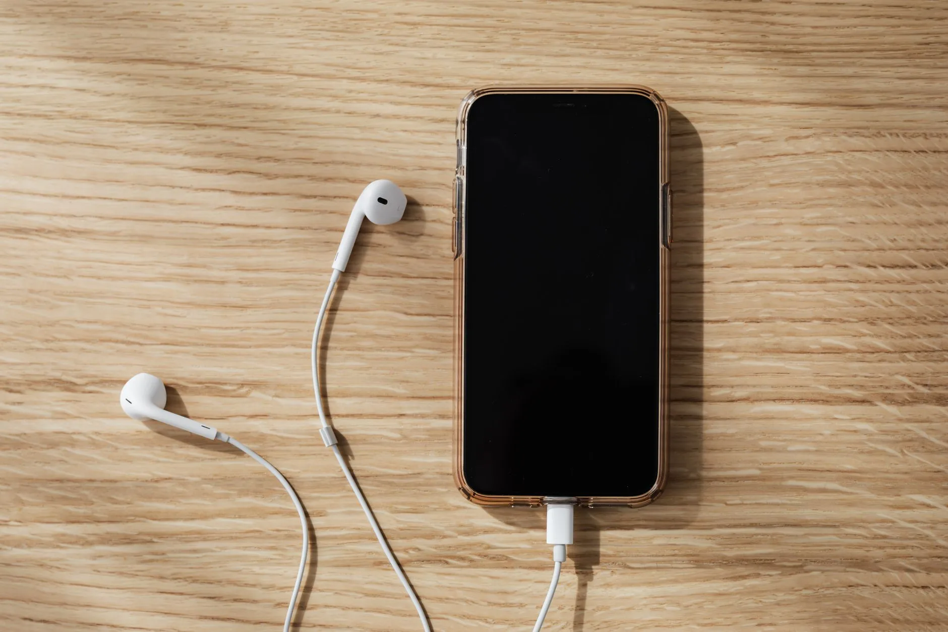Headphones and compact audio accessories arranged on a desk